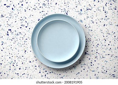 Mockup Background For Food Stylist Presentation. Top View Of Empty Plate On White And Blue Terrazzo Background. 3d Render Illustration. Clipping Path Of Each Element Included.