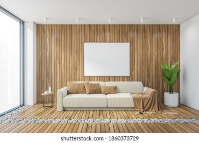 Mockup Canvas Frame In Big Wooden Living Room With Sofa And Wooden Floor, White Wall. Front View Of Modern White Couch With Brown Pillows, Plant In The Corner 3D Rendering, No People