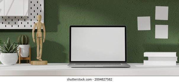 Mock-up Laptop Screen In Modern Workspace With Figure, Plants, Books And Decoration On White Table And Green Wallpaper, 3d Rendering, 3d Illustration