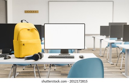 Mockup Of A Pc Monitor On A Desk In A Classroom With A Backpack And Headphones Next To It. Concept Of Education And Back To School. 3d Render