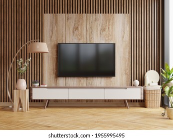 Mockup A TV Wall Mounted In A Dark Room With A Dark Wood Wall.3d Rendering