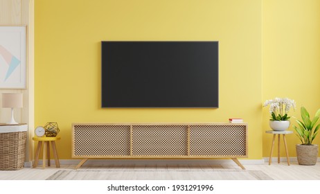 Mockup A TV Wall Mounted In A Living Room Room With A Yellow Wall.3d Rendering