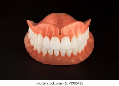 model of teeth. Dentures close-up on a black background isolate. The concept of aesthetic orthopedic dentistry