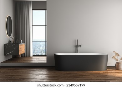 Modern bathroom interior with dark brown parquet floor, white and black bathtub and marble wash basin, side view. Minimalist bathroom with modern furniture and city view. 3D rendering
 - Powered by Shutterstock