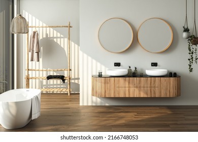 
Modern Bathroom Interior With Dark Brown Parquet Floor, Two Sinks, Double Mirrors, White Bathtub, Interior Plants, Front View. Minimalist Bathroom With Modern Furniture And City View. 3D Rendering
