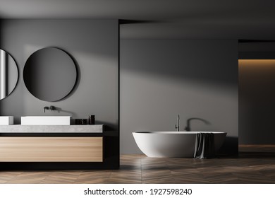 Modern Bathroom Interior With Double Sink And White Bathtub In Eco Minimalist Style With Brown Wooden Parquet Floor. And Two Round Mirrors. No People. 3D Rendering