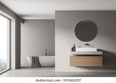 Modern Bathroom Interior With Sink And White Bathtub Near Window In Eco Minimalist Style. No People. 3D Rendering