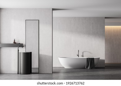 Modern Bathroom Interior With White Bathtub And Marble Sink With Rectangle Vertical Mirror, In Eco Minimalist Style With Concrete Floor And Walls. No People. 3D Rendering