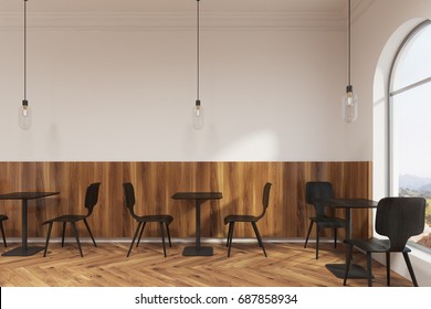 Modern Black Chairs Are Standing Near Square Wooden Tables In A Coffee Shop Or A Restaurant With A Wooden Floor And White Walls. 3d Rendering