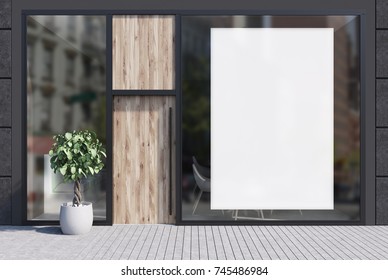 Modern Cafe Exterior With Black Walls, A Wooden Door, A Huge Vertical Poster On A Mirror Like Window And A Potted Tree Near The Entrance. 3d Rendering Mock Up