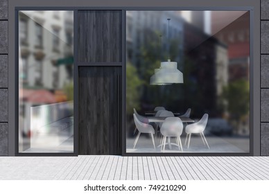 Modern Cafe Exterior With Black Walls, A Dark Wooden Door And Large Windows. It Is Standing In An Empty Street With A White Stone Pavement. 3d Rendering Mock Up