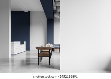 Modern cafe interior with empty wall for mockup, minimalist furniture on concrete material floor, white and blue background, concept of space for advertisement. 3D Rendering