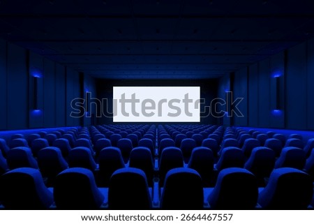 Modern cinema interior with rows of empty seats and blank white screen in front, clean layout with blue lighting, dark background. 3D Rendering