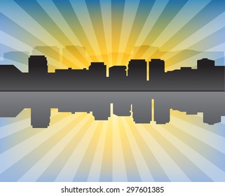 Modern cityscape at sunset with sunrays and reflection