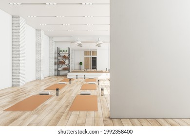 Modern Concrete Yoga Gym Interior With Equipment, Blank Mockup Space On Wall, Daylight And Wooden Flooring. Healthy Lifestyle Concept. Mock Up, 3D Rendering