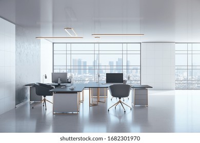 Modern Coworking Office Interior With Personal Computers On Table And City View. Workplace And Company Concept. 3D Rendering