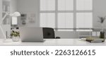 Modern doctor office with laptop, table lamp, stationery and decor on white table over blurred background. doctor