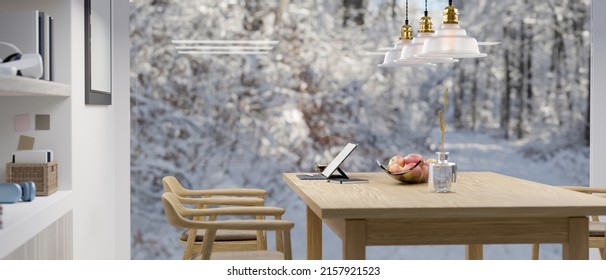 Modern home dining room with laptop computer and decor wooden dining table against the large glass window with snow view. 3d rendering, 3d illustration