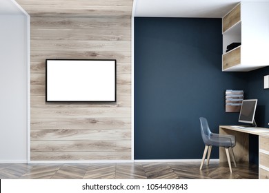 Modern Home Office Interior With Dark Blue, White And Wooden Walls, A Wooden Floor, A Computer Desk With Bookshelves Hanging Above It And A Mock Up TV Screen On The Wall. 3d Rendering