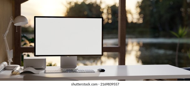 Modern Home Workplace Interior Design With PC Computer Desktop Mockup For Display Your Graphic And Accessories On Table Over Blurred Beautiful Nature Lake In Background. 3d Rendering, 3d Illustration