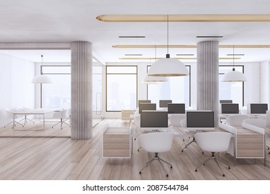 Modern Industrial Coworking Loft Office Interior With Furniture, Computer Monitors, Wooden, Flooring And Window With City View And Daylight. Workplace And No People Concept. 3D Rendering