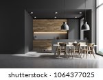 Modern kitchen interior with gray and white brick walls, a concrete floor and gray and wooden countertops. A long table with chairs near it. A mock up wall. 3d rendering