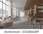 Modern library interior with table and chairs in row, bookshelf with pc computer on grey concrete floor. Stylish learning workplace in public loft with modern furniture. 3D rendering