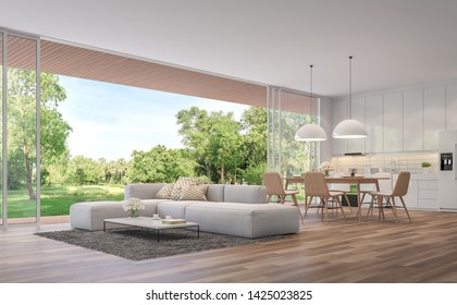 Modern Living, dining room and kitchen with garden view 3d render.The Rooms have wooden floors ,decorate with white furniture,There are large open doors. Overlooks wooden terrace and large garden.