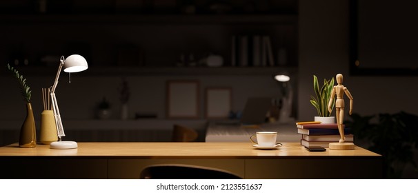 Modern luxury office space or workstation with office supplies and copy space for product display on wooden table under warm lights in the dark room at night. 3d rendering, 3d illustration
