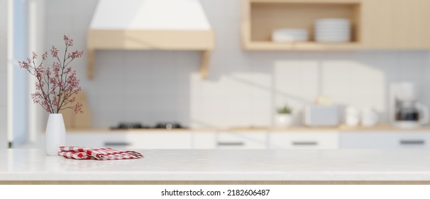 Modern luxury white kitchen tabletop and decors   copy space for montage your product display over blurred modern kitchen space in the background  3d rendering  3d illustration
