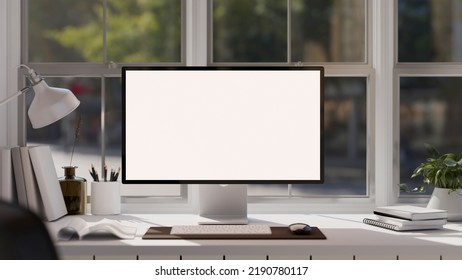 Modern Minimal Office Desk Workspace Against The Window With White Screen Desktop Computer, Keyboard, Mouse And Office Accessories. Close-up Image. 3d Rendering, 3d Illustration