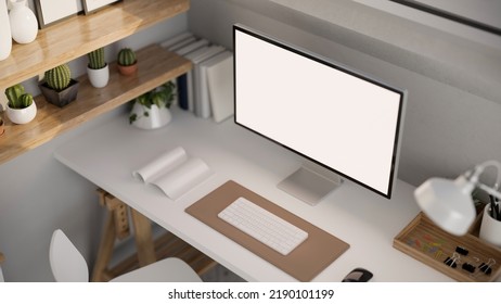 A Modern Office Desk Workspace With White PC Desktop Computer Mockup, Keyboard, Office Accessories And Decor On White Table. Above View Rendering, 3d Illustration