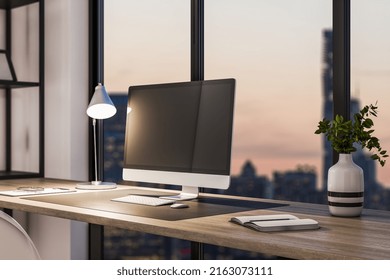 Modern Office Interior With Book Shelves, Furniture, Panoramic City View At Dawn And Empty Mock Up Computer Screen. Creative Designer Desktop Concept. 3D Rendering