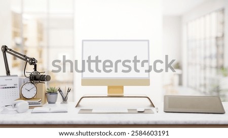 A modern podcaster office features a computer with a white screen mockup, a graphic tablet, a microphone, and decorative items on a desk. 3d render, 3d illustration