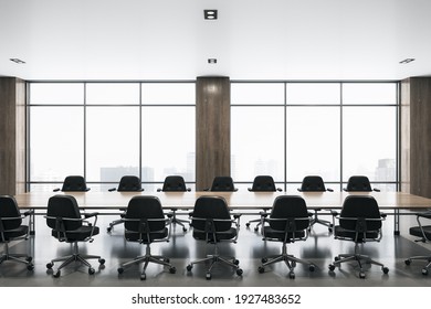 Modern Spacious Meeting Room With Big Window, Wooden Table In The Center And Black Chairs Around. 3D Rendering