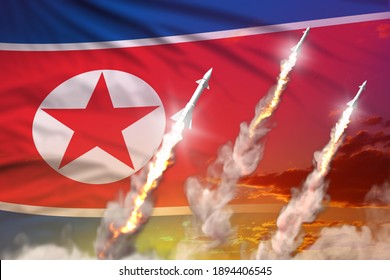 Modern strategic rocket forces concept on sunset background, North Korea ballistic warhead attack - military industrial 3D illustration, nuke with flag
