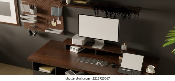 Modern Urban Dark Loft Home Workspace Interior Design With PC Computer And Tablet Mockup On Dark Wood Table, Pegboard And Wall Shelves On Black Wall. 3d Render, 3d Illustration