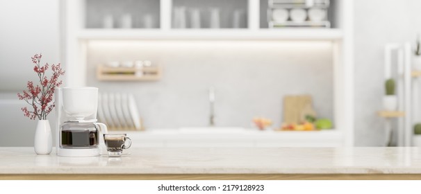 Modern white kitchen tabletop or countertop with coffee maker, a cup of coffee, flower vase and copy space over blurred modern elegance bright kitchen in the background. 3d rendering, 3d illustration - Shutterstock ID 2179128923