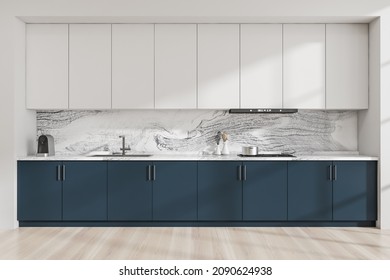 Modular Kitchen Cabinet Interior With Minimalist Blue And White Design And Marble Look Splashback. Light Wood Floor. Concept Of Modern House Design. 3d Rendering