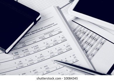 Monochrome daily financial reports, pen and notepad - Powered by Shutterstock