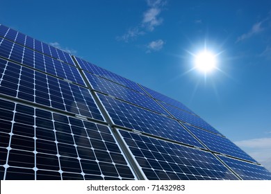 mono-crystalline solar panels against a sunny sky