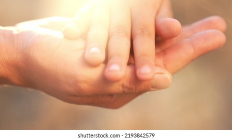 Mother Holds The Hand Of A Newborn. Close-up Of A Children Hand. Hospital Takes Care Of Happy Family Concept. Newborn Baby Holding Mom Hand Close-up. Medicine Mom Takes Care Of Baby In Hospital