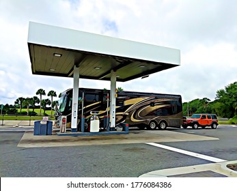 Motorhome (RV) Recreational Vehicles Getting Gas At Truck Stop Island