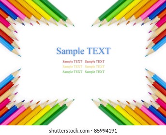 Multi colored pencils in a corner on a white background with space for text