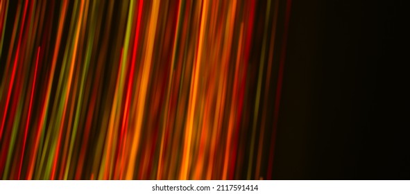 Multi Colored Rays On A Dark Background. Abstraction. Drawing With Light. Photo Effect.