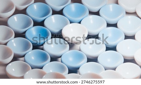 Multiple empty bowls creating a colorful pattern with one bowl standing out, symbolizing diversity, uniqueness and conformity