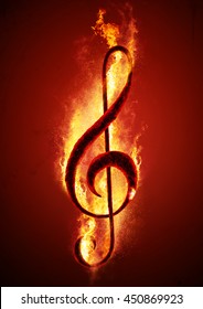 Musical note (treble clef) from hot charcoal on fire. Conceptual image of hot music.