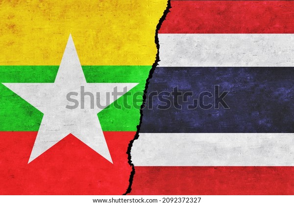 Myanmar and Thailand painted flags on a wall with\
a crack. Thailand and Myanmar relations. Myanmar and Thailand flags\
together. Thailand vs\
Myanmar