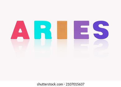 Name ARIES is in 12 Zodiac isolated on white background. Colorful wooden alphabets set sort. English letter made of wood arrange alphabet as categorize suitable for children. Poster, banner design. 