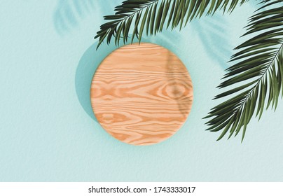 Natural Empty Wood Cylinder Box On Blue Concrete Floor Background With Tropical Palm Leaves. For Product Display. Flat Lay. Top View. 3d Render.